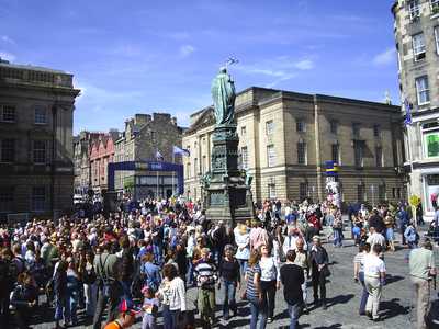 Crowds watch street entertainers on the High Street during the Festival